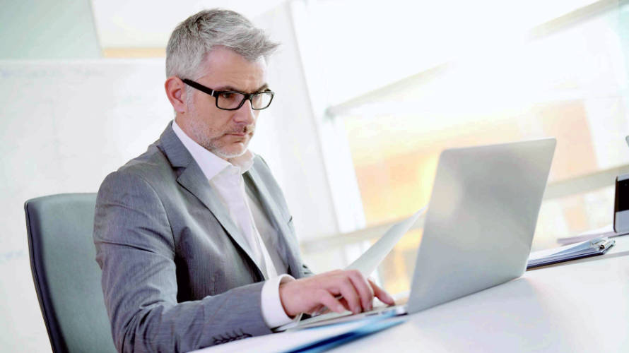 businessman-in-office-working-on-laptop